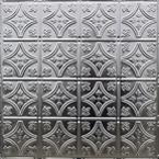A silver metal wall with a pattern of crosses.