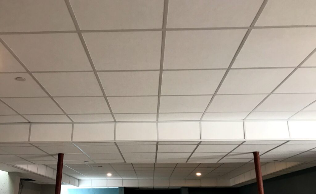 A ceiling with many white tiles on it