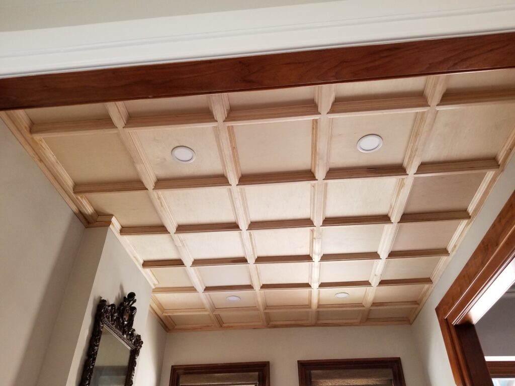 A ceiling with wooden beams and a mirror
